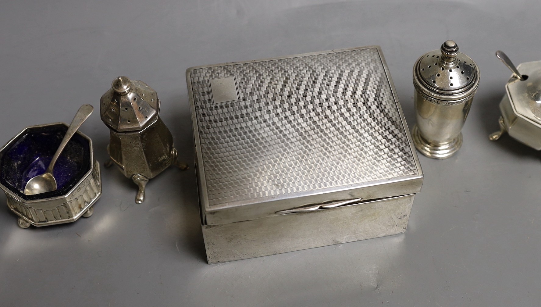 Six assorted silver condiments and a silver mounted cigarette box.